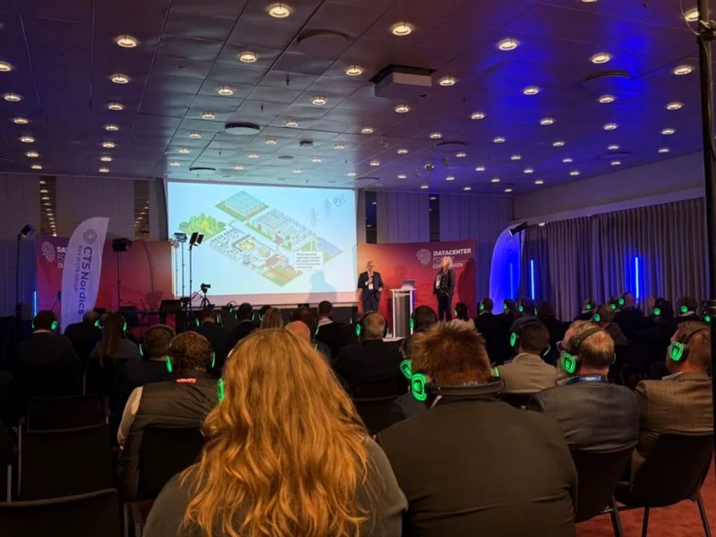 Audience using GoSilent headsets during a presentation